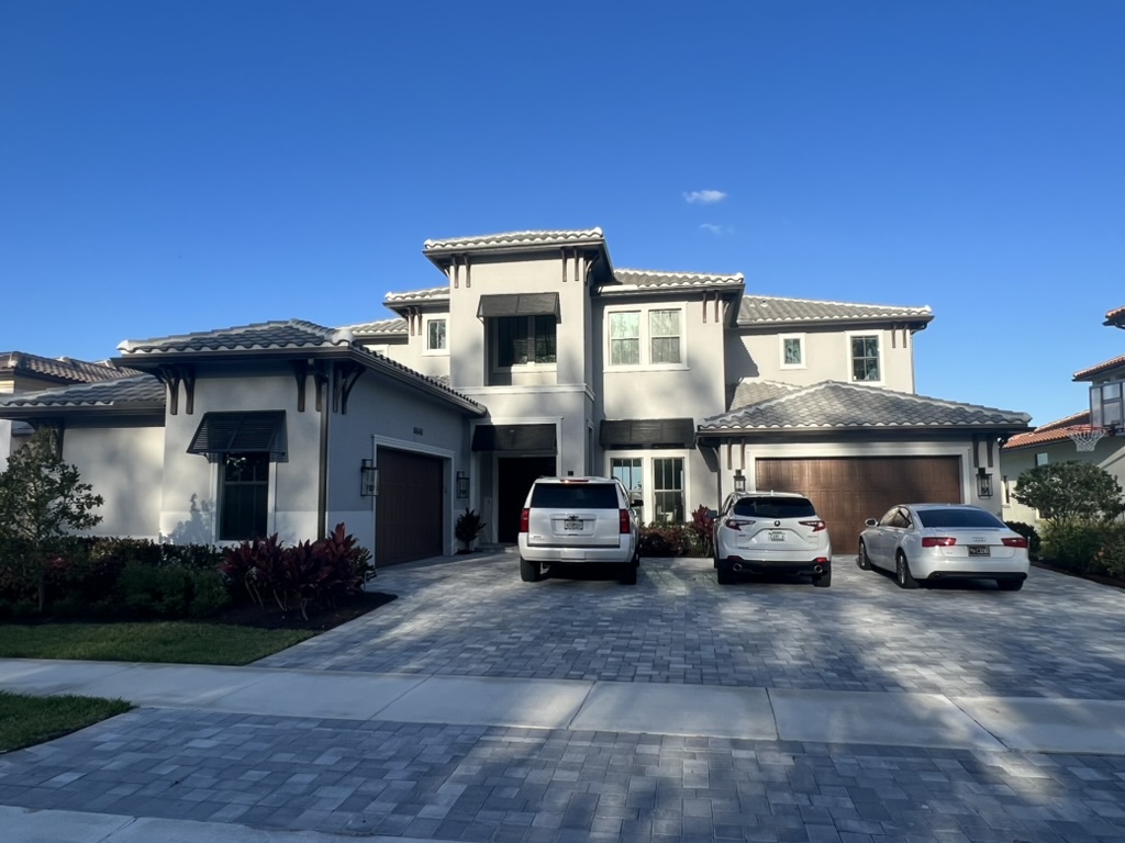 Two-story home with a paved driveway and landscaped front yard
